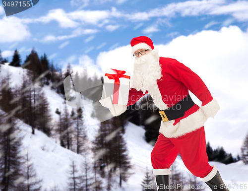 Image of man in costume of santa claus with gift box