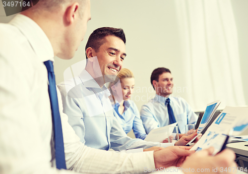 Image of smiling business people meeting in office