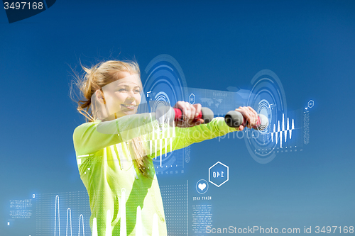 Image of sporty woman with light dumbbells outdoors