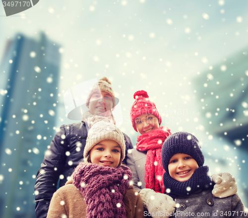 Image of happy family in winter clothes outdoors
