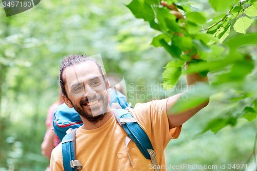 Image of group of smiling friends with backpacks hiking