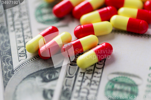 Image of medical pills or drugs and dollar cash money