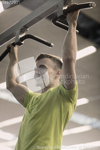 Image of smiling man exercising in gym