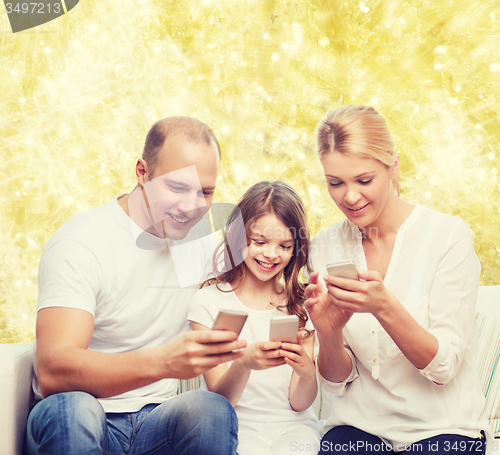 Image of happy family with smartphones