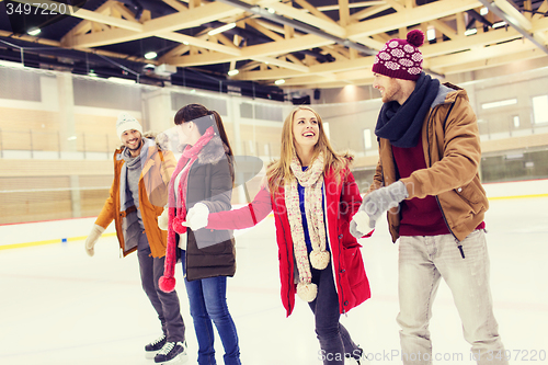 Image of happy friends on skating rink