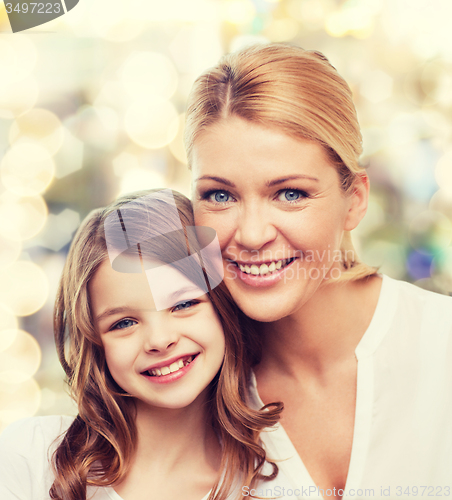 Image of smiling mother and little girl