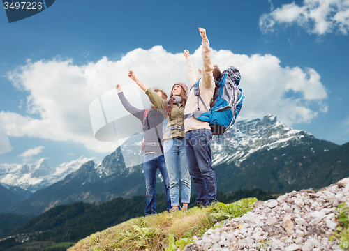 Image of group of smiling friends with backpacks hiking