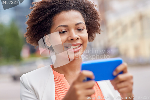 Image of happy african businesswoman with smartphone