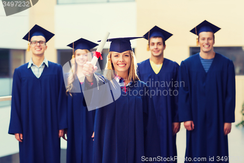 Image of group of smiling students in mortarboards