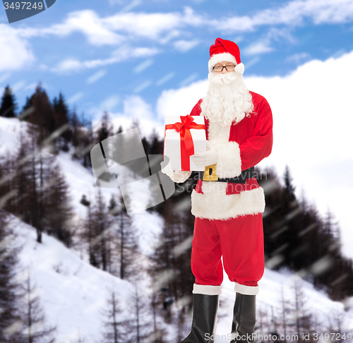Image of man in costume of santa claus with gift box