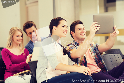 Image of group of smiling students with tablet pc