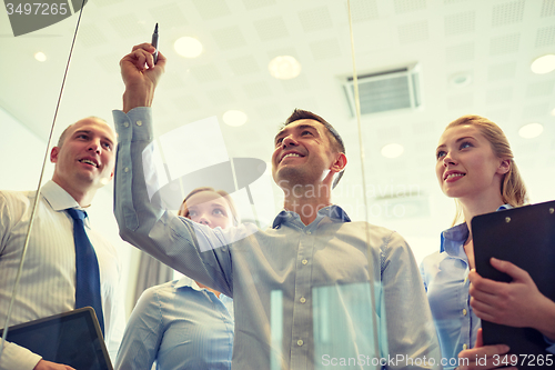 Image of smiling business people with marker and stickers