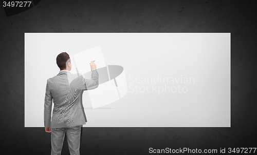 Image of businessman writing or drawing on white board