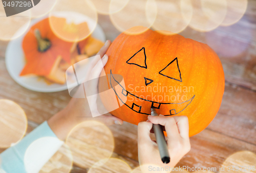 Image of close up of woman with pumpkins at home