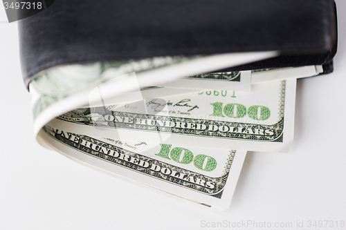 Image of close up of usa dollar money in wallet on table