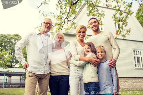 Image of happy family in front of house outdoors