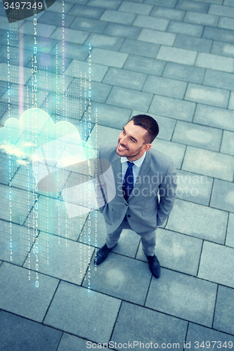 Image of young smiling businessman outdoors from top