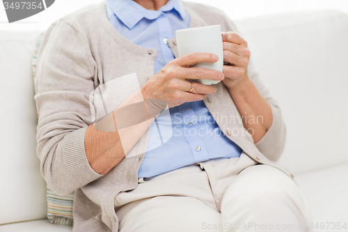 Image of close up of senior woman with tea  cup at home