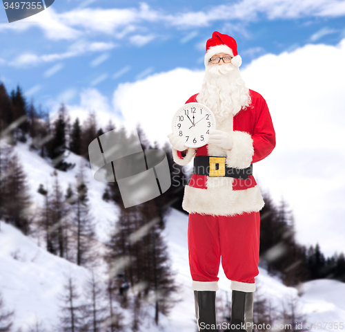 Image of man in costume of santa claus with clock