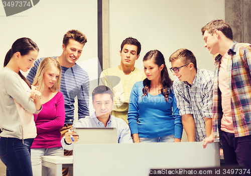 Image of group of students and teacher with laptop