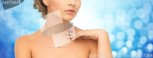 Image of close up of woman wearing shiny diamond pendant