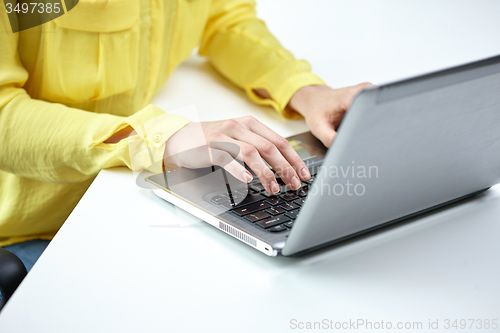 Image of close up of woman with laptop computer in office