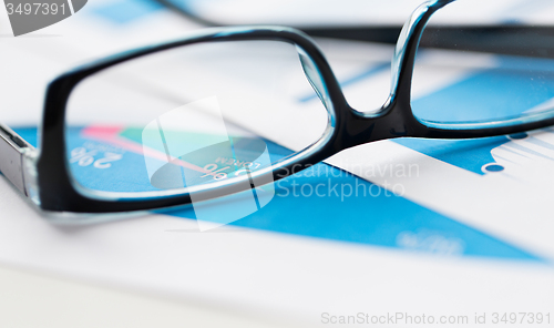 Image of close up of eyeglasses and files on office table