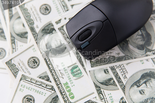 Image of close up of computer mouse and usa dollar money