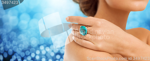Image of close up of woman hand with ring and precious gem