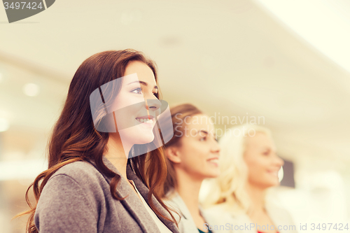 Image of happy young women in mall or business center