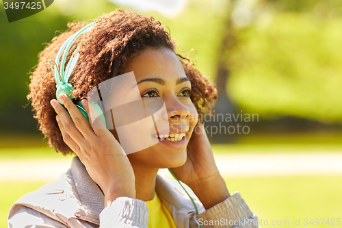 Image of african woman in headphones listening to music