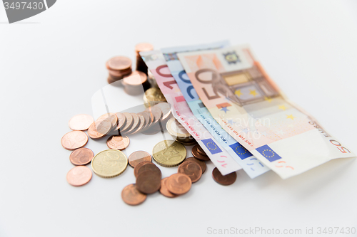 Image of close up of euro paper money and coins on table