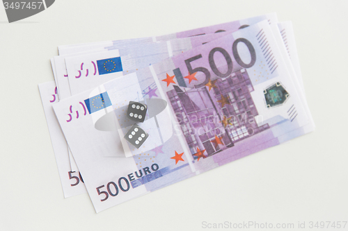 Image of close up of black dice and euro cash money