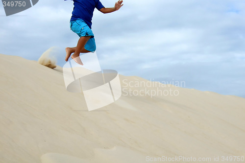 Image of Child playing in the sand dune in South of Brazil
