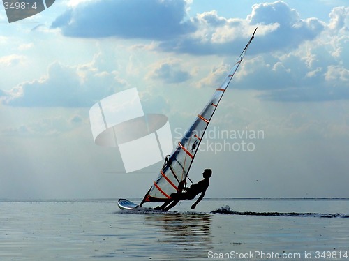 Image of Silhouette of a wind-surfer on waves of a gulf