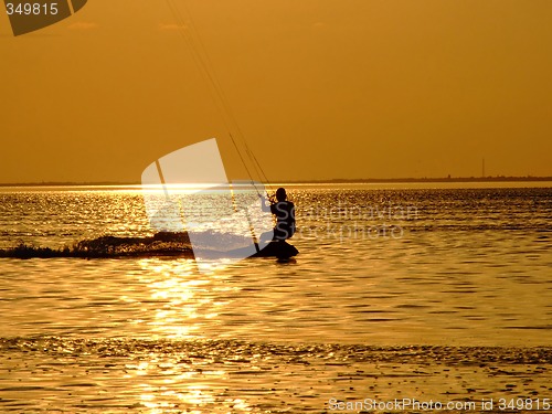 Image of Silhouette of a kite-surf on waves of a gulf on a sunset 1