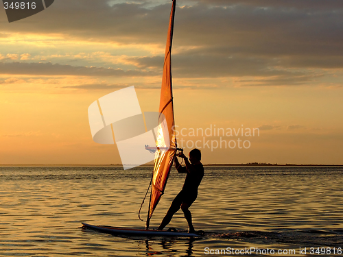 Image of Silhouette of a wind-surfer on waves of a gulf on a sunset 2