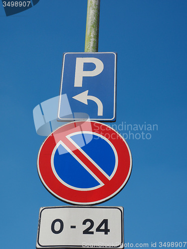 Image of No parking sign over blue sky