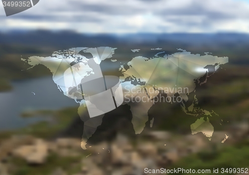 Image of Polygonal world map on blurred landscape background