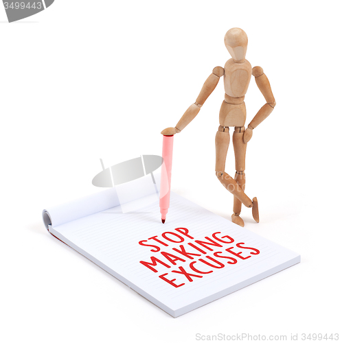 Image of Wooden mannequin writing - Stop making excuses