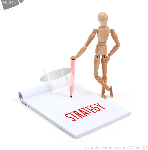 Image of Wooden mannequin writing - Strategy