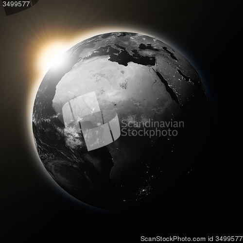 Image of Sun over Africa on dark planet Earth