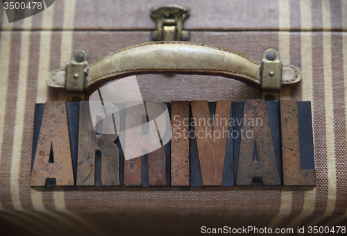 Image of arrival word on old luggage