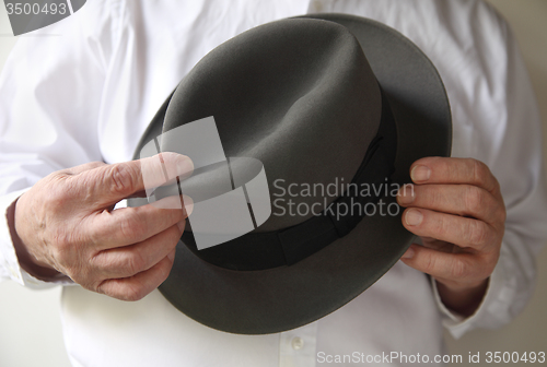 Image of businessman with an old felt hat	