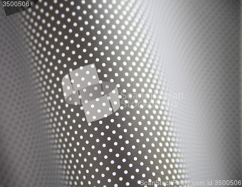 Image of curving gray and white polka dot background