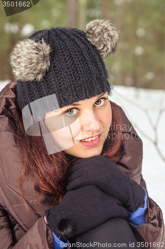 Image of Portrait of the charming young woman in winter outdoors 
