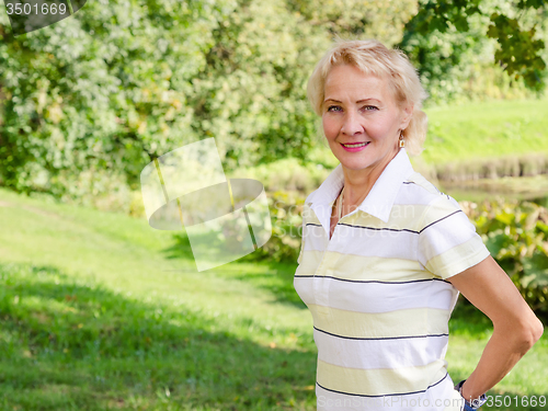 Image of Portrait of a middle-aged woman in a park on a sunny day