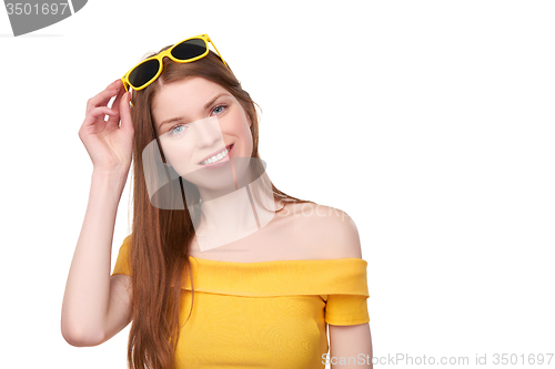 Image of Smiling redheaded female in yellow top and sunglasses