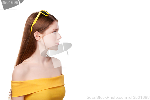 Image of Redheaded female in yellow top and sunglasses