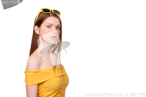 Image of Redheaded female in yellow top and sunglasses